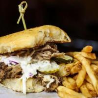 Pulled Pork Sandwich · Pulled pork, BBQ sauce, cole slaw, pickles and onions on a jalapeno cheddar bun