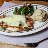 Chicken Telge · Grilled chicken breast topped with sliced ham, sauteed mushrooms, Swiss cheese and covered w...