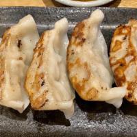 Gyoza · Pan-fried pork dumpling, spicy dipping.