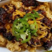 Dignowity Pie · Corn chips topped with Sharp Cheddar Mac, Pulled Pork OR Brisket Burnt Ends, Cheddar Cheese,...