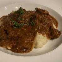 Gulas · traditional Bosnian thick beef stew served over mashed potatoes.
