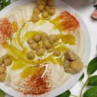 Hummus & Pita Bread · Vegetarian. Ground chickpeas mixed with tahini sauce topped with olive oil.