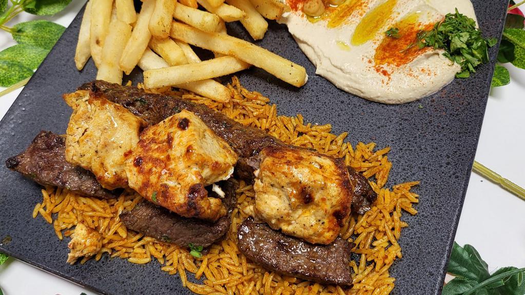 Mixed Grill Platter · Grilled marinated chicken pieces, grilled marinated pieces of lean beef, one skewer of spiced ground beef, over a bed of rice.