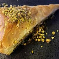 Baklava · Phyllo dough layers stuffed with pistachio, topped with honey.