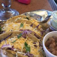 Tiki Taco Plate · Two tacos (chicken, ground beef, pork). Rice and beans. 20 oz soft drink.