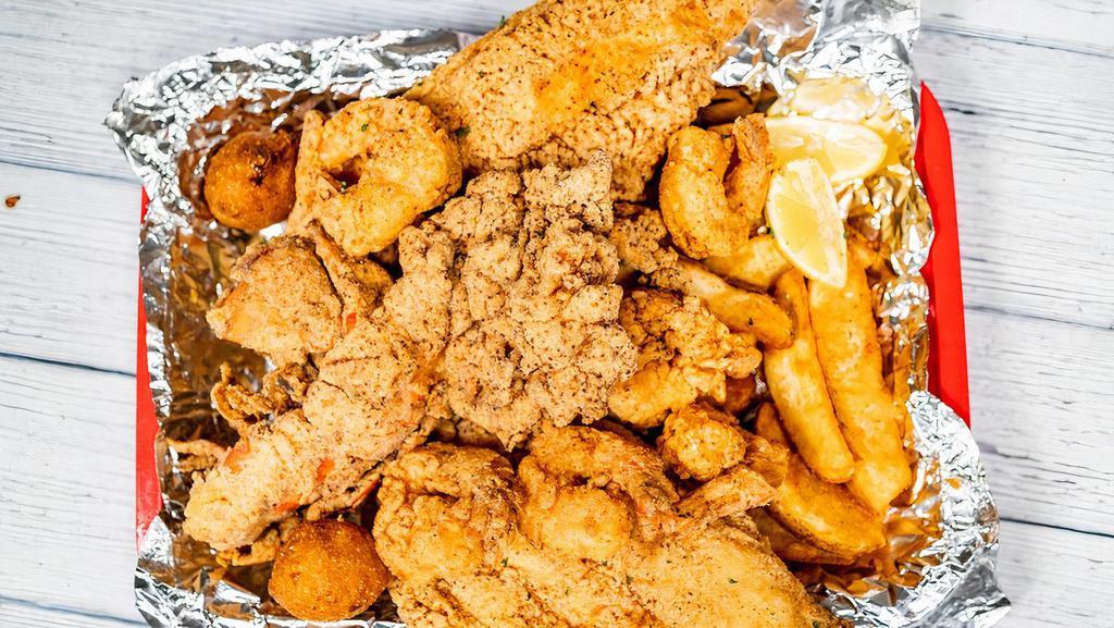 Fried Catfish, Shrimp, And Lobster · 2 pc fried catfish, 10 fried shrimp, and a fried lobster, hush puppies, and fries