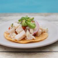 Tostada De Ceviche · Lime juice cured fish served with freshly pre-mixed pico de gallo and topped with slices of ...