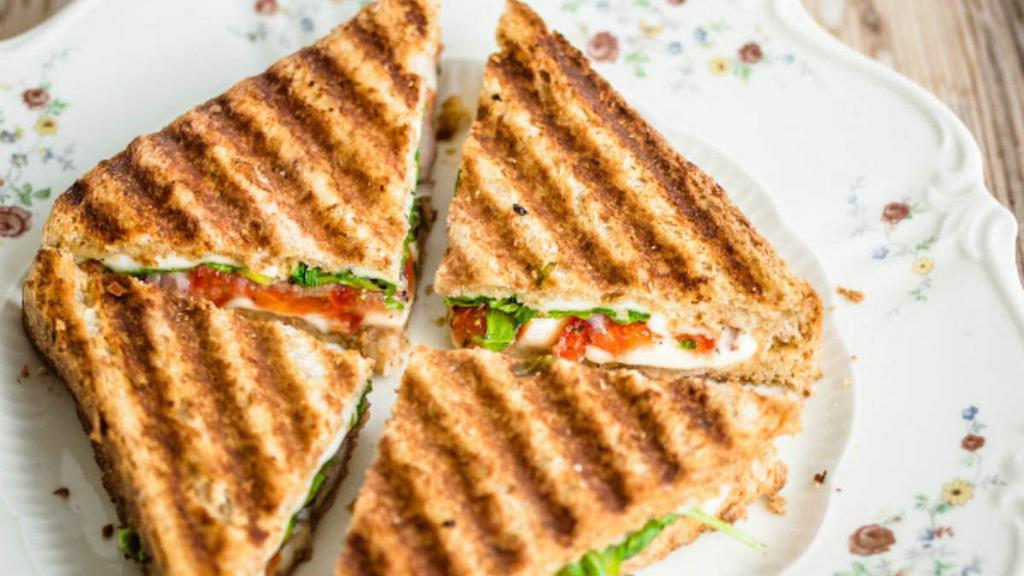 Grilled Club Sandwich · Wheat beard, mayo, ham, turkey, bacon, lettuce, tomato, cheese.