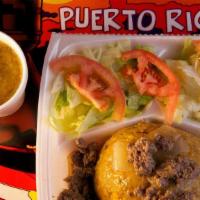 Mofongo Relleno De Bistec Encebollado Co Plate · Fried green plantain stuffed beef tec with onions and salad.