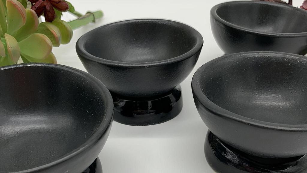 Cerámica Suro: Mezcal / Tequila Tasting Cups · Custom made in a hand fired kiln these are a one-of-a-kind product from Cerámica Suro in Guadalajara, Mexico.. Includes a set of 4 matte black ceramic cups and 4 glazed black rings to set the tasting cup in.