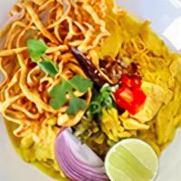 Kao Soy Chicken · A traditional Northern Thai Curry noodle dish served with chicken, pickled cabbage, red onio...