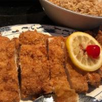 Lemon Chicken · Large fried chicken breast garnished with a lime slice cherry and served with lemon sauce on...