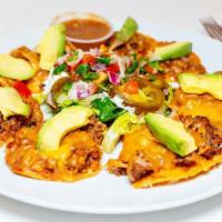 Pub Nachos · Eight large freshly fried corn tortillas topped with refried beans, taco meat, blended chees...