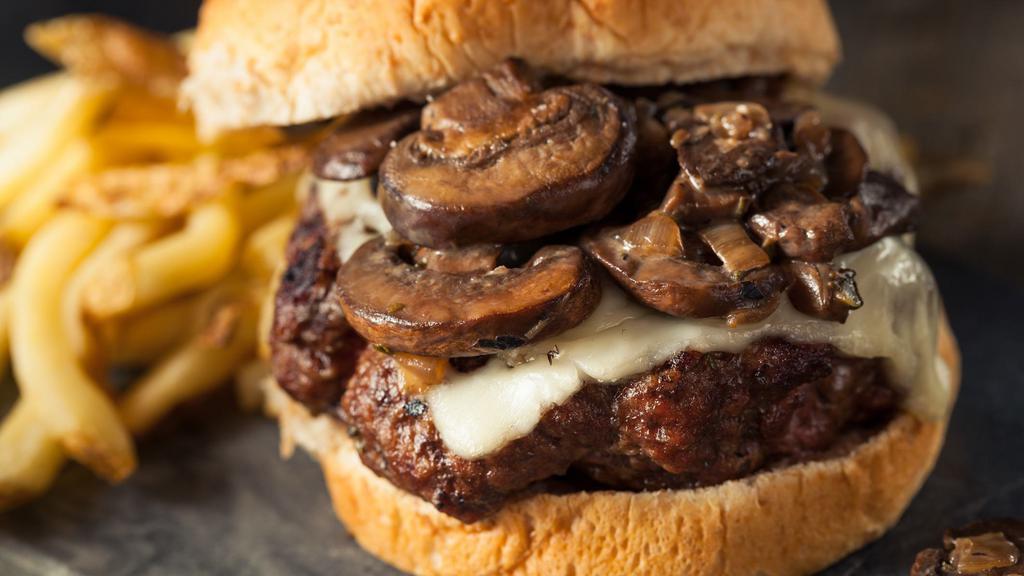 Mushroom Swiss Burger · 7 oz burger with mushrooms, swiss cheese, grilled onion and mayo on a toasted brioche bun.