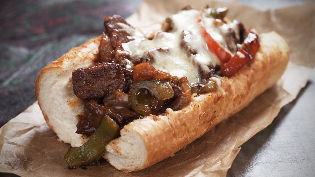 Philly Cheese Steak Sandwich · Chopped rib eye steak with bell peppers, grilled onion, mushrooms on a hoagie roll.