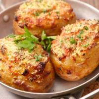 Baked Potato · Baked potato stuffed with brisket, smoked sausage or grilled chicken, butter, cheese and sou...