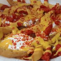 Flamin' Chilli Cheese Fries. · French Fries, Chilli, Sheaddar Cheese, Flaming Hot Cheetos, Nacho Cheese and Sour Cream.