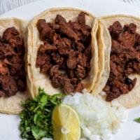 Taco Crispy · Three tacos tostados de fajita de res y pollo (three fried beef and chicken fajita tacos).