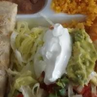 El Chicano · One taco de fajita de res, one enchilada de pollo (one beef fajita taco, one chicken enchila...