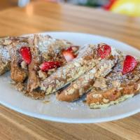 Strawberry Banana Oatmeal French Toast (V) · Our decadent homemade strawberry banana bread dipped in seasoned egg mix. Topped with powder...