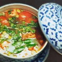 Tom Yam · Spicy lemon grass soup with chili paste, straw mushroom, onion, and cilantro.