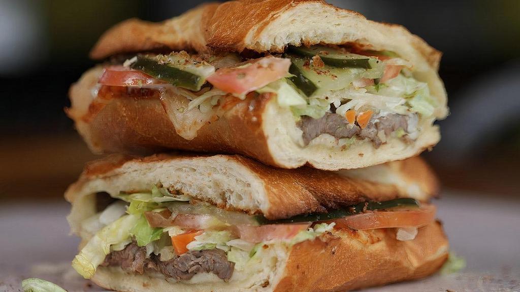 New York Steak & Provolone Cheese · Served with ALL TOPPINGS: . Mayo, Mustard, Hot Peppers, Onion, Lettuce, Tomato, Pickle, Seasoning & Oil