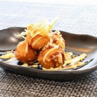 Takoyaki · Five pieces. Octopus ball, bonito flakes with wasabi mayo and eel sauce.