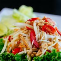 Som Tam Thai (Green Papaya Salad) · Fresh shredded green papaya mixed with ground peanuts, tomatoes, garlic & Thai special lime ...