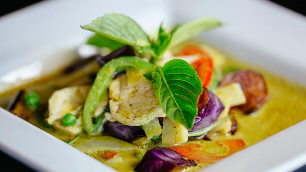 Green Curry · Green curry paste in coconut milk with bell peppers, eggplant, bamboo shoots, sweet peas & fresh basil leaves.