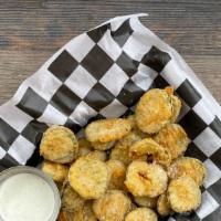 Dill Chips · Thick-cut and hand-battered dill pickle chips golden-fried. Served with buttermilk-ranch.
