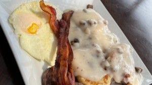 Biscuits & Gravy Combo · Two of our fresh buttermilk biscuits, split, then smothered with our homemade sausage gravy, served with a sausage patty, two strips of bacon and two eggs, any style