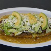 Super Huarache · Fried Masa stuffed with Beans—topped with Tomatillo Salsa, Meat of your choice, Lettuce, Que...