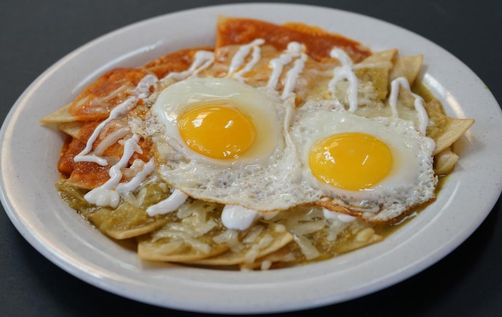 Chilaquiles · Crispy Fried Tortilla Chips, with Green Tomatillo Salsa  with Chicken OR Egg—Topped with Cheese and Sour Cream with Beans on the Side