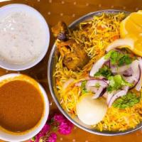 Chicken Dum Biryani · Classic mughlai dish of chicken and eggs cooked with fragrant rice and Indian spices