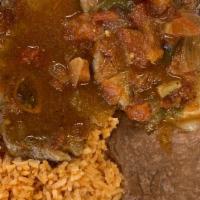 Pork Chop Ranchero · Two pieces of pork chop with ranchero sauce on top, served with rice, refried beans, salad a...