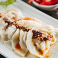 Spicy Dumplings (5)  · Steamed dumplings stuffed with shrimp and chicken mushroom. Served with sesame chili oil sau...
