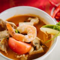 Tom Yum With Shrimp · Thai soup with shrimp, lemon grass, mushrooms, lime juice, and topped with green onions.