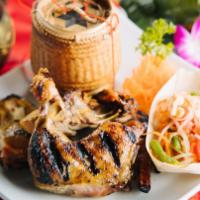 Bbq Chicken / Ping Gai · Laotian-style grilled chicken. Half pound chicken marinated and grilled over fire. Served wi...