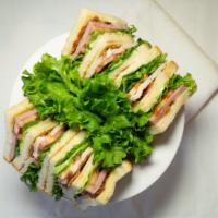 Tommy'S Club Sandwich · A triple decker served with ham, turkey and bacon, lettuce, tomatoes, swiss cheese and mayo ...