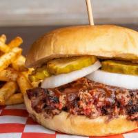 Prime Brisket Chopped Sandwich · Served on a toasted bun with onions, pickles and BBQ sauce.  Choose two made from scratch si...