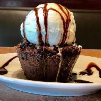 D’Lux Brownie · Chocolate chip brownie topped with vanilla ice cream and chocolate syrup. (CONTAINS NUTS)