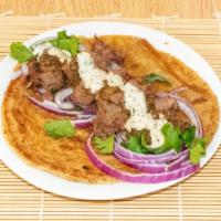 Beef Bihari Boti · Spicy, marinated, charcoal grilled, melt in your mouth, beef, onions, and chutney, wrapped i...