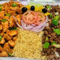 Chicken And Beef Over Rice Platter · Half tray of rice with chicken and beef, served with salad. White sauce on the side.