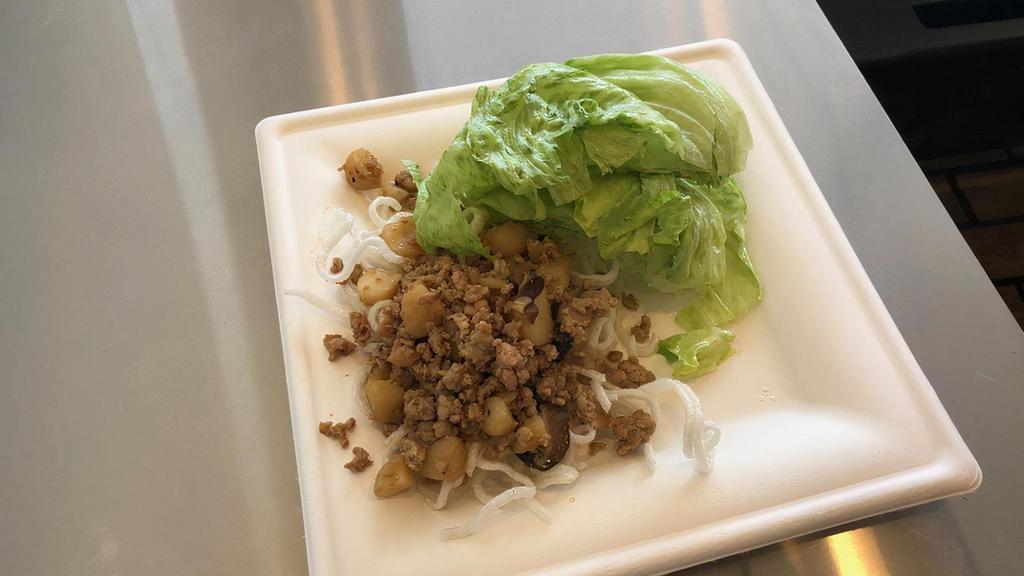 Lettuce Wraps · Marinated Chicken with Water Chestnuts and Shiitake Mushrooms, served over crispy rice sticks and a side of Iceberg Lettuce wraps. This item is a great low carb option.