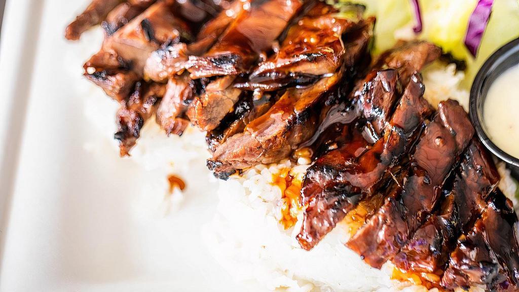 Teriyaki Beef Plate · Over a half pound of marinated steak, grilled to perfection. Covered in fresh teriyaki sauce and served over a bed of rice with a simple side salad.