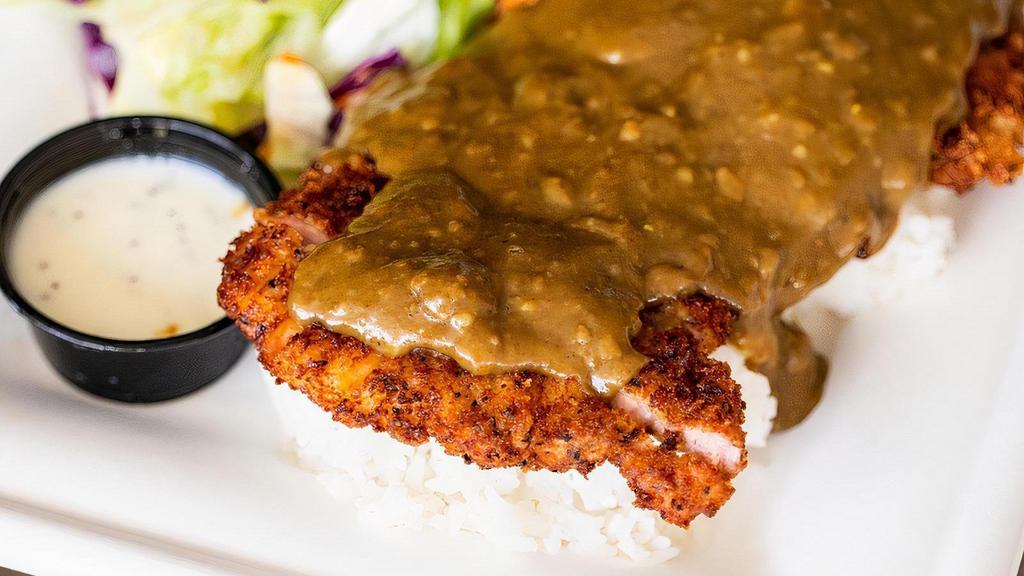 Katsu Curry Chicken · Panko breadcrumb coated chicken served with a traditional Japanese Curry sauce over the top. The meal comes with Calrose rice and a side salad.