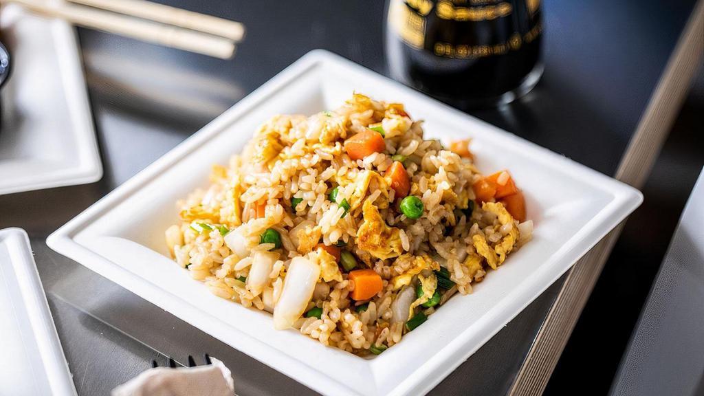 Side Fried Rice · A side order of fried rice - carrots, peas, onions and rice. Made with sesame oil and garlic.