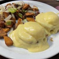 Eggs Benedict · Canadian style bacon on an English mufﬁn topped with poached eggs & smothered with rich holl...