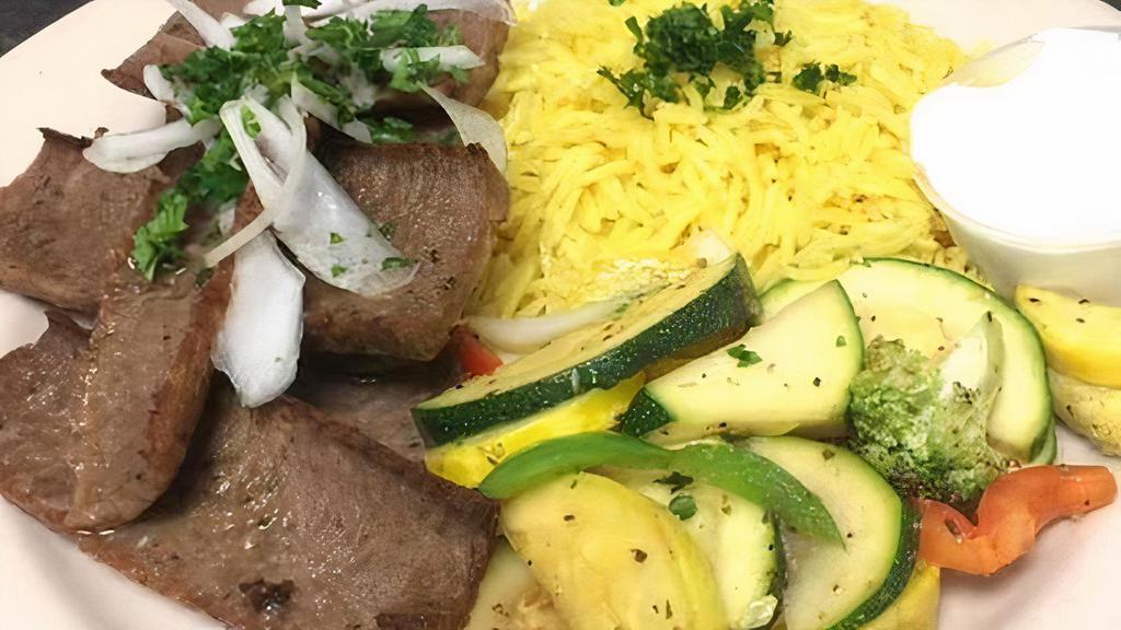 Gyro Plate · Seasoned lamb and beef gyro meat roasted on Sababa's rotating spit grill. Served with tzatziki sauce. Comes with rice, grilled vegetables, fresh pita bread, and your choice of side.