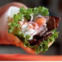 Gyro Sandwich · Seasoned gyro meat wrapped with lettuce, tomato, onion, and tzatziki sauce.
